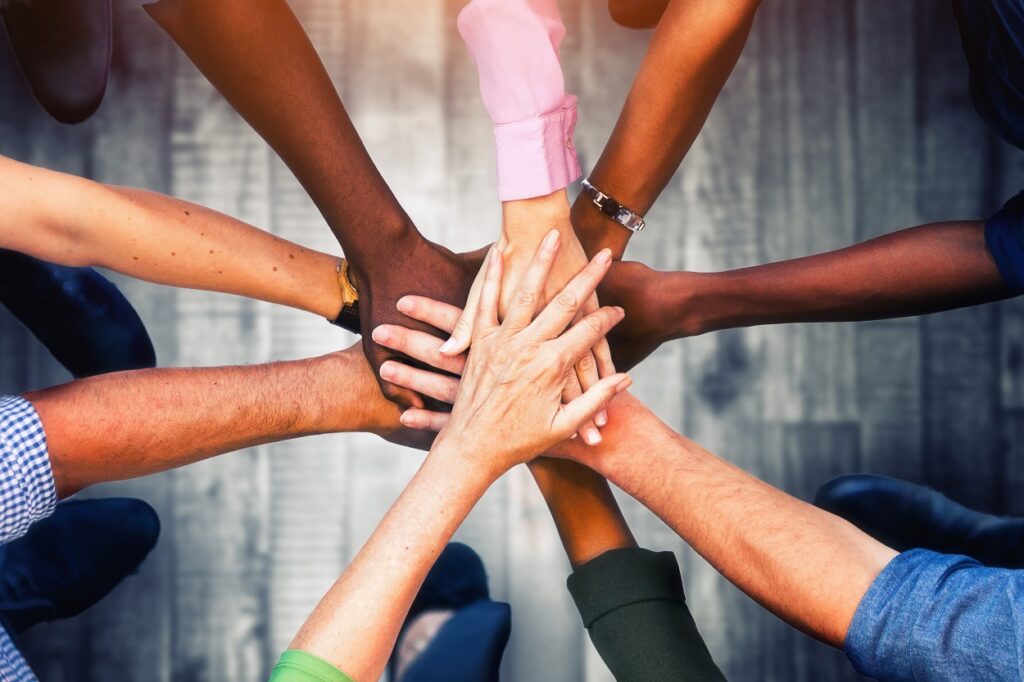 Close,Up,View,Of,Young,Business,People,Putting,Their,Hands